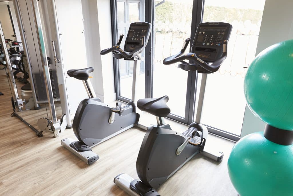 Empty gym with exercise equipment professionally cleaned